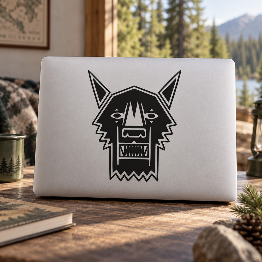 Geometric wolf head decal with black outline and angular ears on a white surface