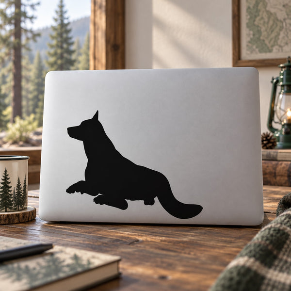 Resting wolf silhouette decal with black design on a light background