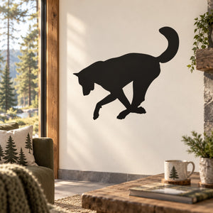 Wolf silhouette wall decal showing a black digging wolf