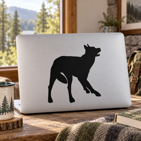 Black wolf silhouette decal with wagging tail on matte laptop lid