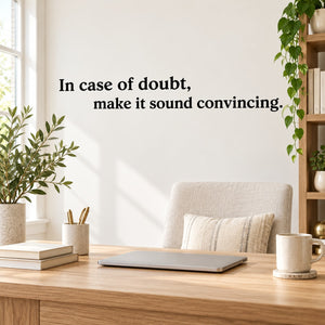 Wall quote decal with black text: In case of doubt, make it sound convincing.
