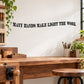 Wall quote decal with black uppercase text: MANY HANDS MAKE LIGHT THE WORK