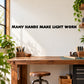 Wall quote decal: “Many hands make light work” in bold black letters