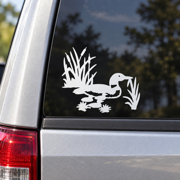 Vinyl car decal with white loon and duck silhouette on dark window