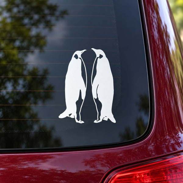 White penguin couple decal with two facing penguins, mounted on a dark surface