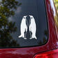 White penguin couple decal with two facing penguins, mounted on a dark surface