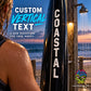 Black vertical text decal with white letters reading COASTAL on a post.
