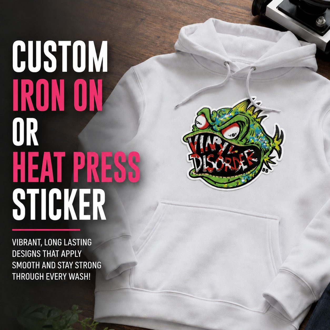 Custom iron-on or heat-press sticker on white hoodie with colorful cartoon logo patch