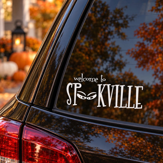Halloween vinyl decal on car window reading “welcome to Spookville” in spooky style