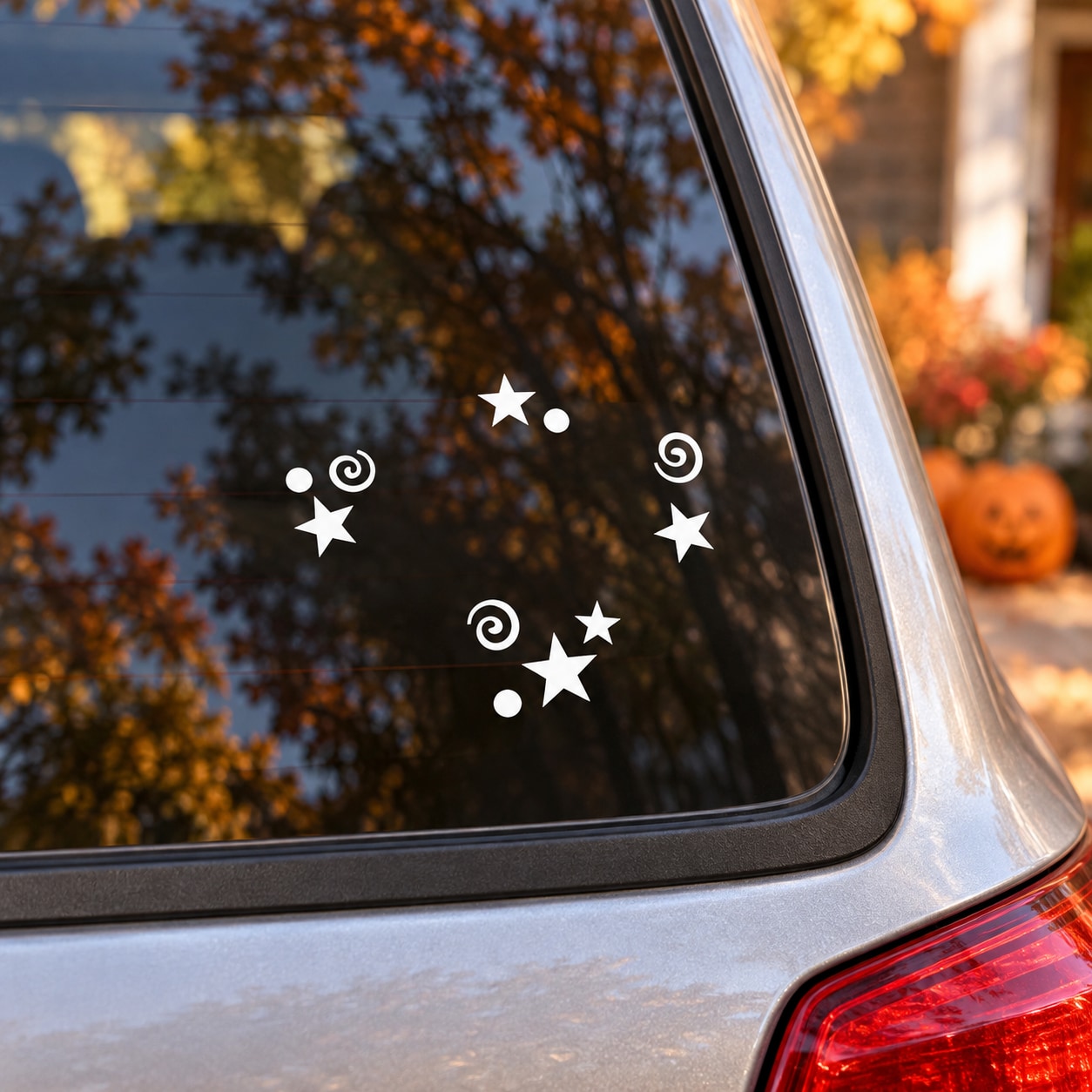 Vinyl star and swirl window decal stickers in white on a car side glass