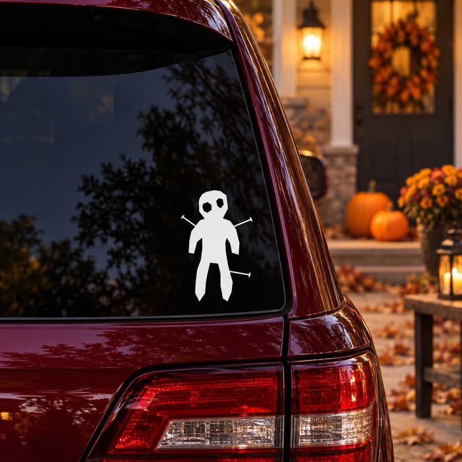 White voodoo doll decal sticker on maroon car rear window