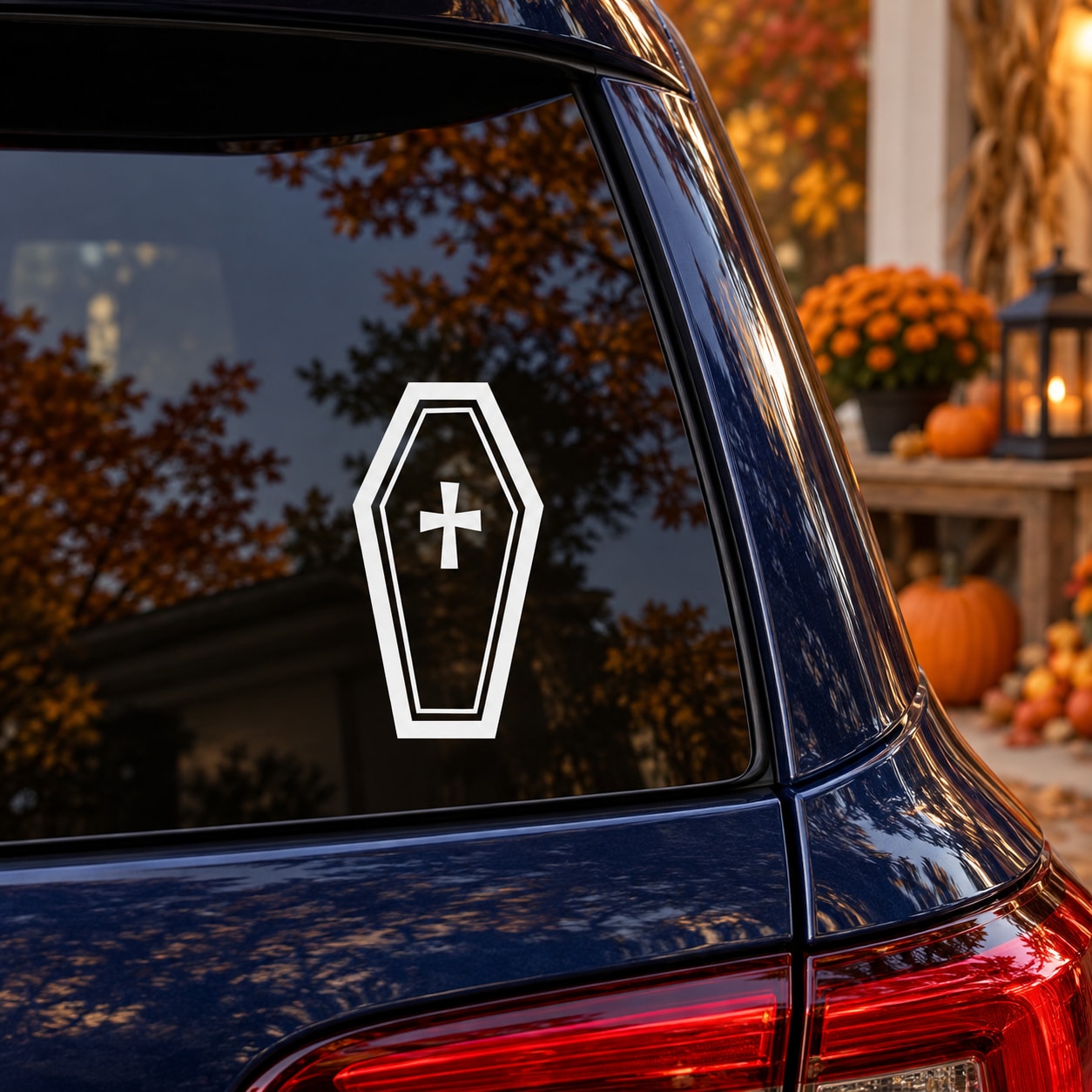 Black and white coffin-shaped light decal with cross symbol on car window
