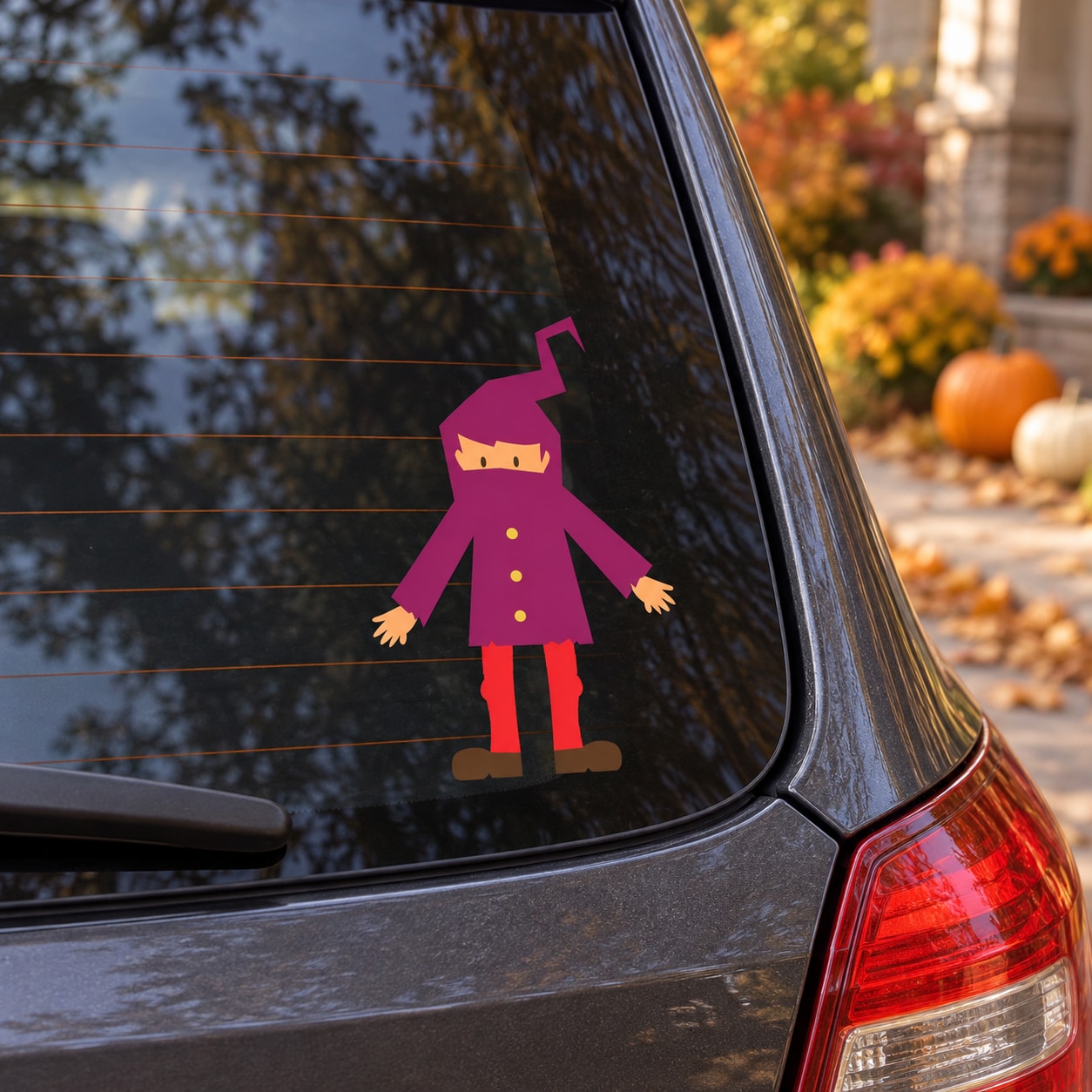 Trick-or-treater character sticker on rear side window with purple coat and red pants