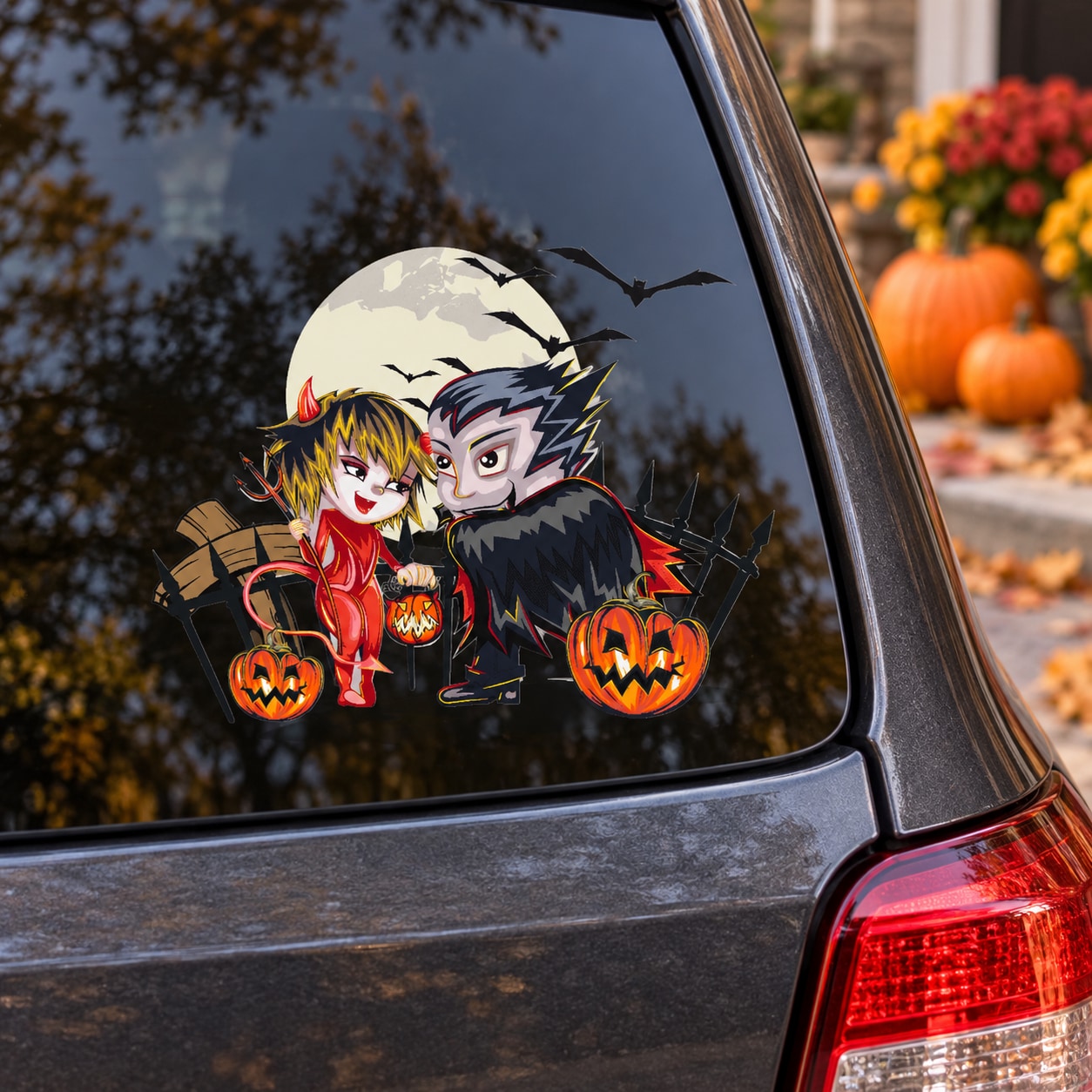 Halloween devil and Dracula character decal on car window with bats and jack-o’-lantern pumpkins