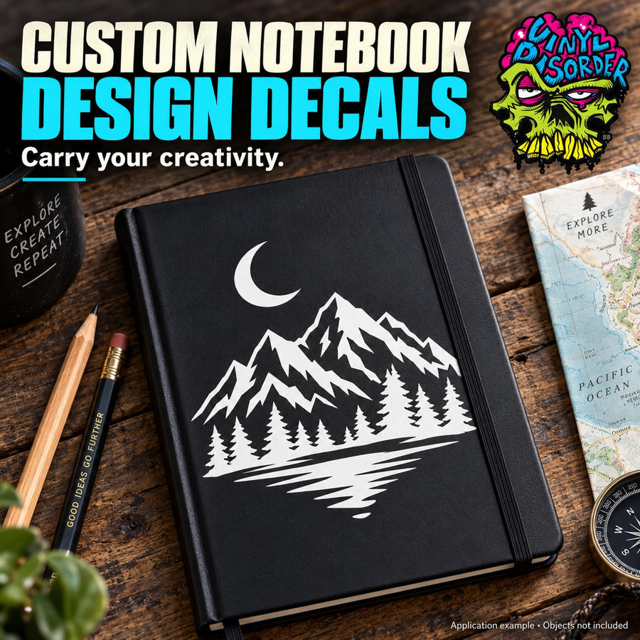 Black hardcover notebook with moon and mountain illustration on front.