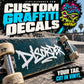 Graffiti-style vinyl decal with white tag lettering on blue-green skateboard deck