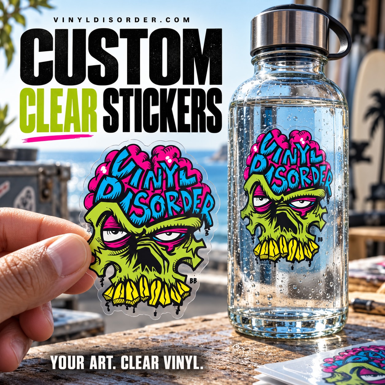 Clear vinyl custom sticker with colorful monster skull graphic, held near a water bottle