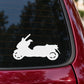 Side-view scooter decal in white on red car side window