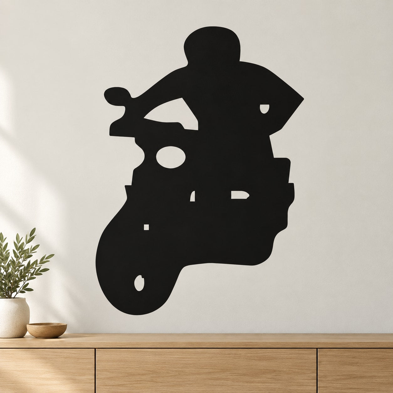 Black scooter rider decal silhouette on a wall