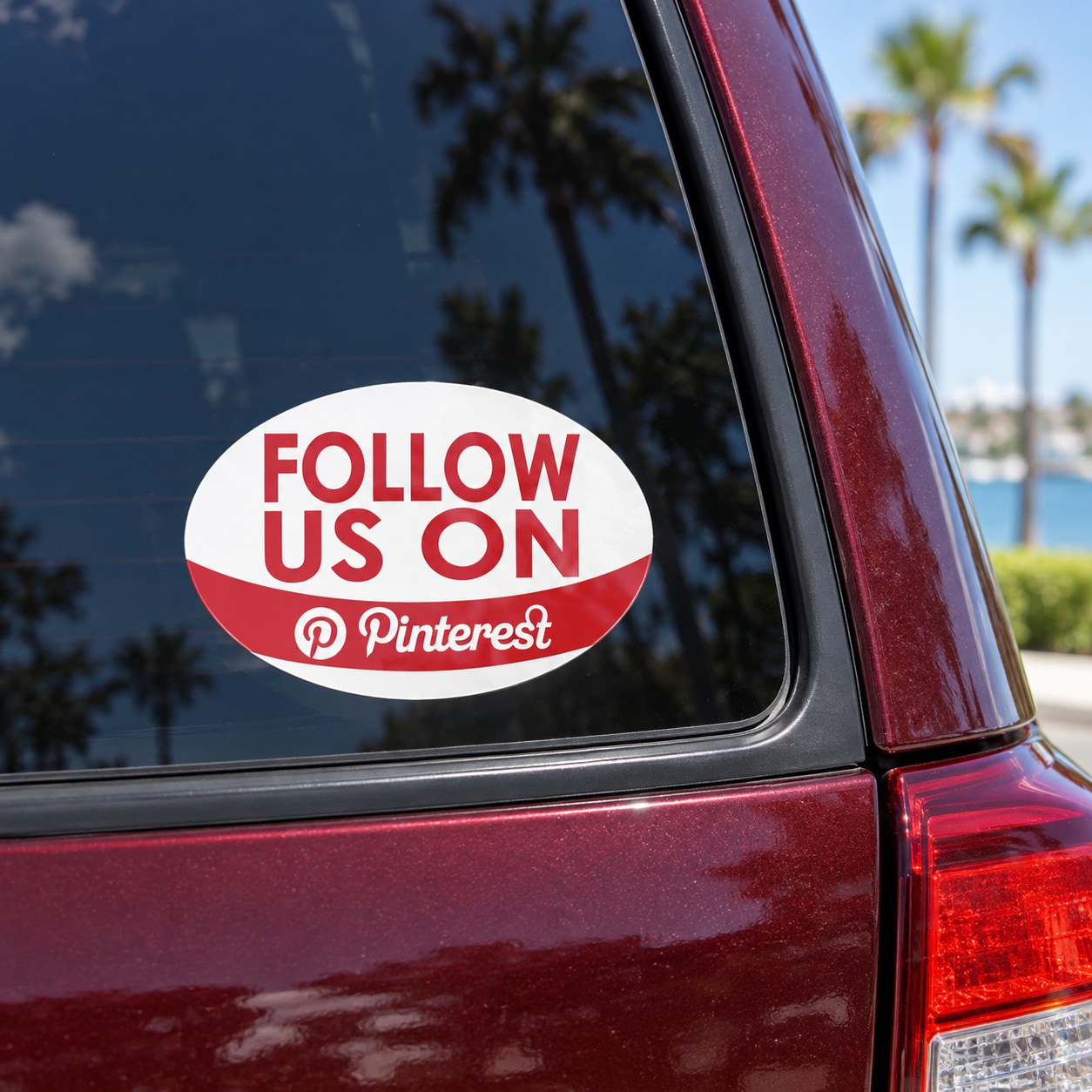 Oval white vinyl car window sticker with red “FOLLOW US ON” and Pinterest @ logo
