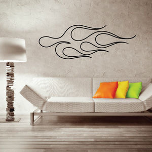 Vehicle pinstripe vinyl decal with black flame swirl lines on a wall