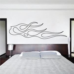 Vehicle pinstripe vinyl decal with black flame swirl lines on a wall