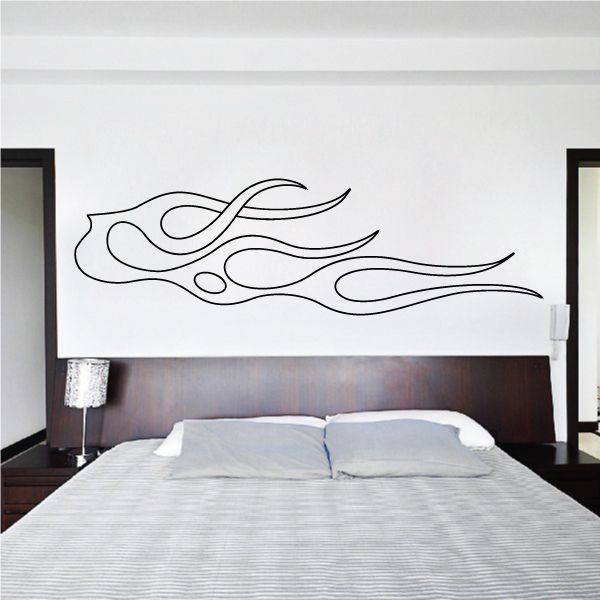 Vehicle pinstripe vinyl decal with black flame swirl lines on a wall