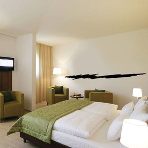 Black pinstripe vinyl decal strip on wall, long sweeping line above bedroom bed.