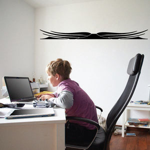 Black pinstripe vinyl decal with swooping double-line graphic on a flat surface