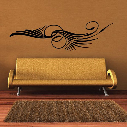 Vehicle pinstripe vinyl decal with dark swirls and winged circular emblem on wall