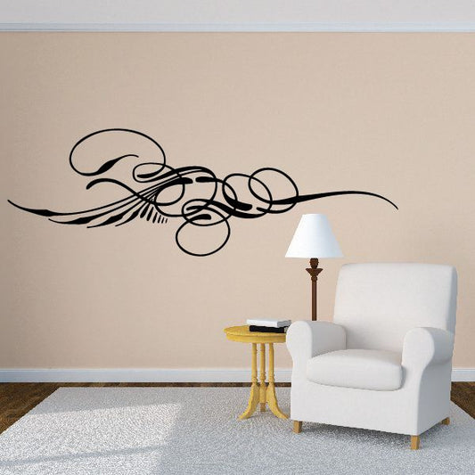 Black pinstripe vinyl vehicle decal with swooping circular curves on wall