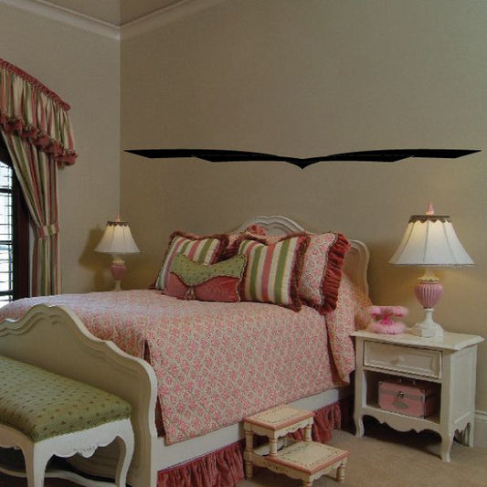 Black pinstripe vinyl decal strip on wall with curved center above bed