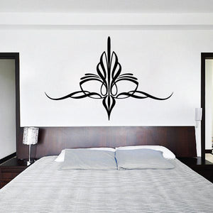 Ornate black vinyl wall decal with symmetrical floral scroll center