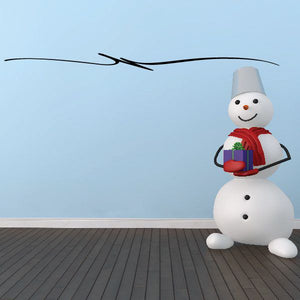 Snowman vinyl decal with red scarf and black dot eyes, on a flat surface