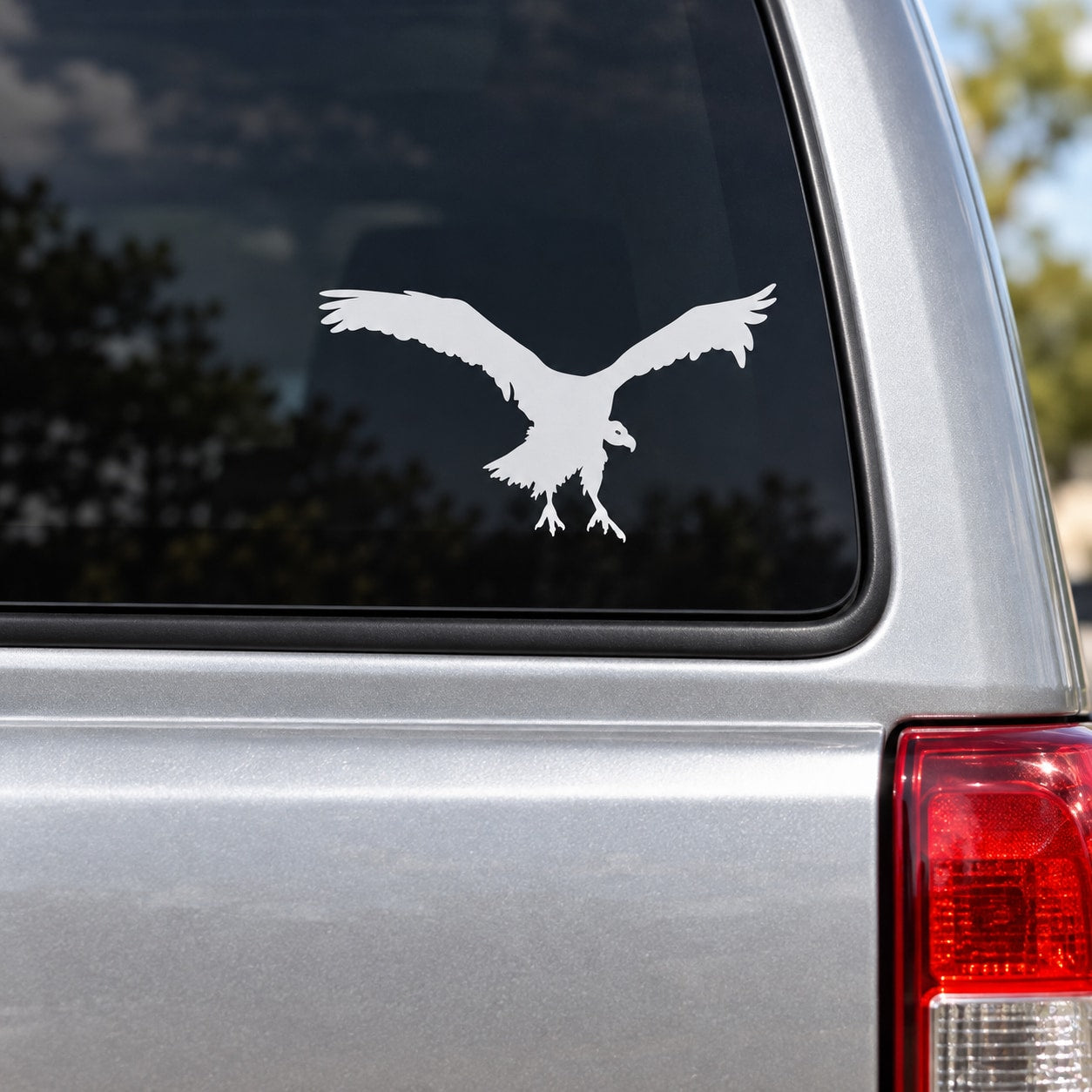 White hovering vulture decal on car window
