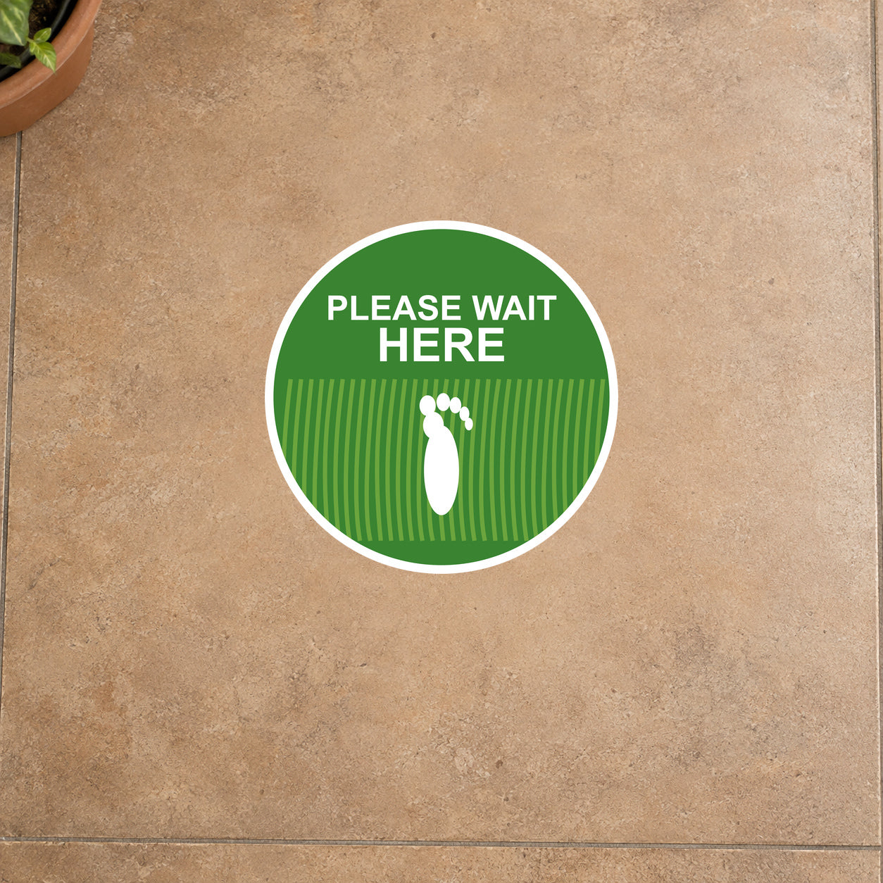 Non-slip circular floor sticker with green 'PLEASE WAIT HERE' text and foot icon