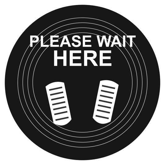 Please Wait Here non-slip flooring sticker, round black sign with white text and arrows