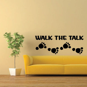 Wall decal with black “WALK THE TALK” text and paw-print trail