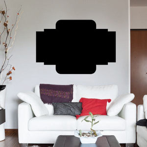 Black vinyl wall decal with cross-shaped center panel above sofa