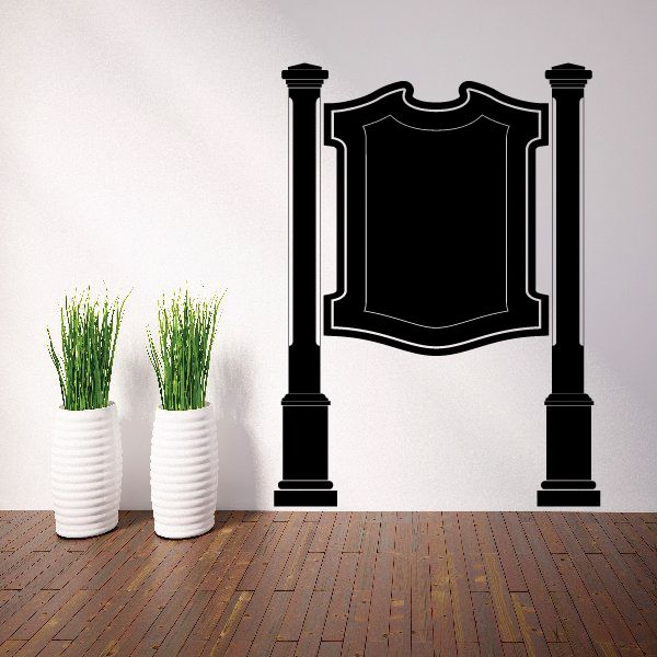 Black vinyl wall decal with two columns and central shield crest