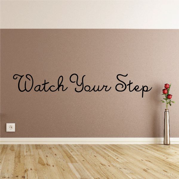 Wall decal: Watch Your Step with cursive lettering and red flower accents