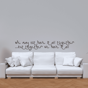 Wall quote decal with handwritten text on a light wall