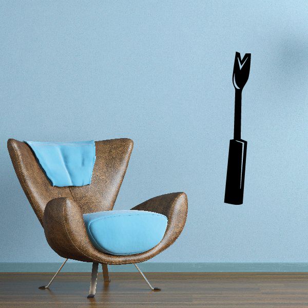 Wall decal: brown armchair with blue cushions and black weed-tool silhouette