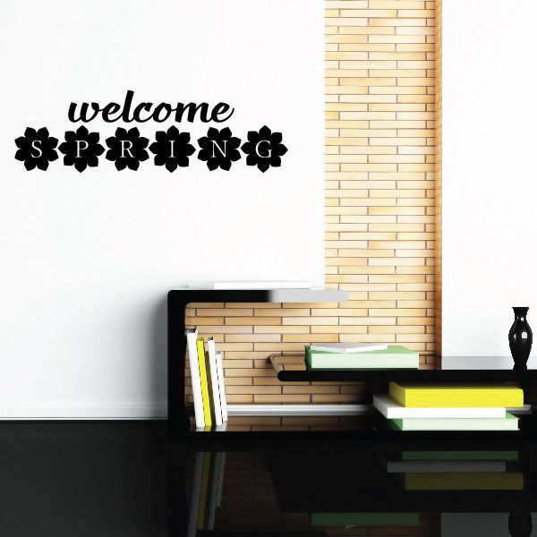 Welcome spring wall decal with black cutout lettering and small flower icons