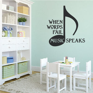 Black wall decal reading 'When Words Fail Music Speaks' with musical note.