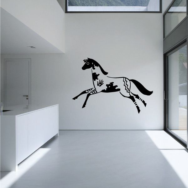 Native-style horse decal with black and white painted details on wall