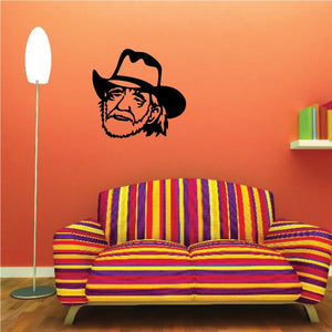 Willie Nelson face decal of man with black hat and glasses, on wall