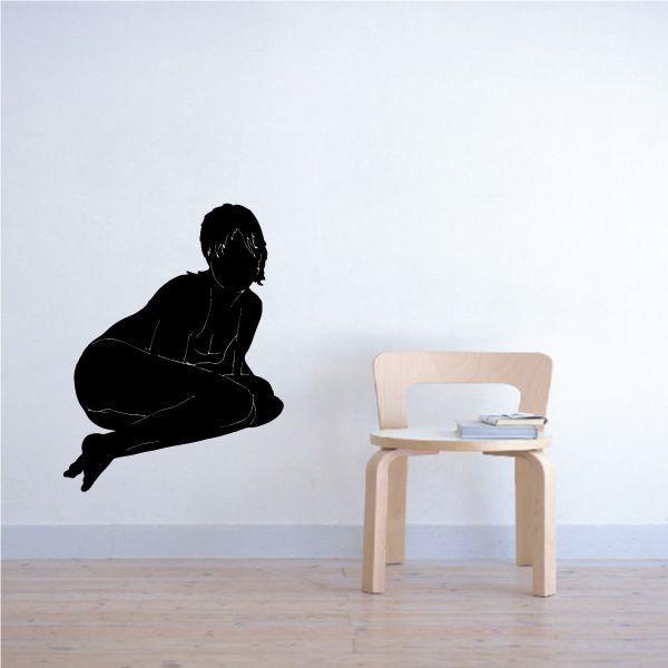 Silhouette wall decal of a kneeling woman looking back, dark figure