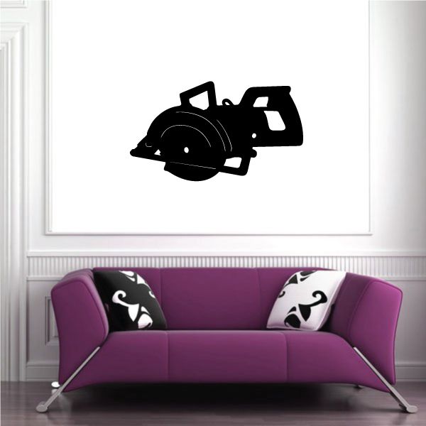 Black worm saw wall decal silhouette above a purple sofa