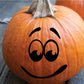 Black worried face decal with frown and teardrop eyes on orange pumpkin